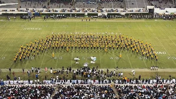 The Mighty Marching Hornets spread across the field in a wide arc before a full stadium